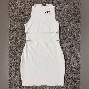 White body con dress with cut outs in the front